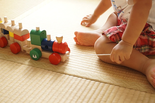 Toddler playing with trains.