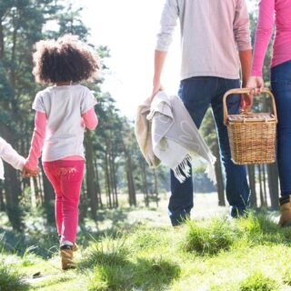 Couple walking with children to picnic.