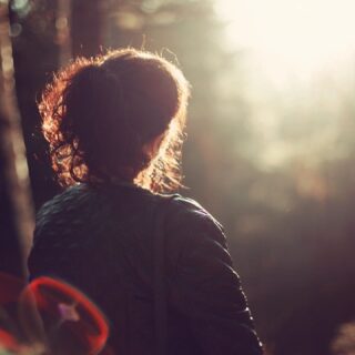 women sitting outside looking into the sun