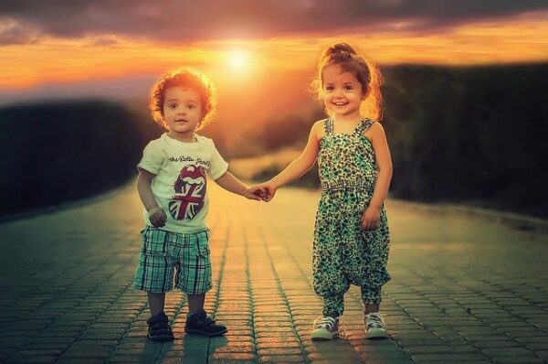 Two little kids holding hands.